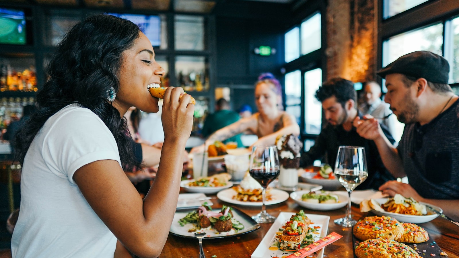 Family and friends enjoying a relaxed shared Italian meal together at a restaurant table